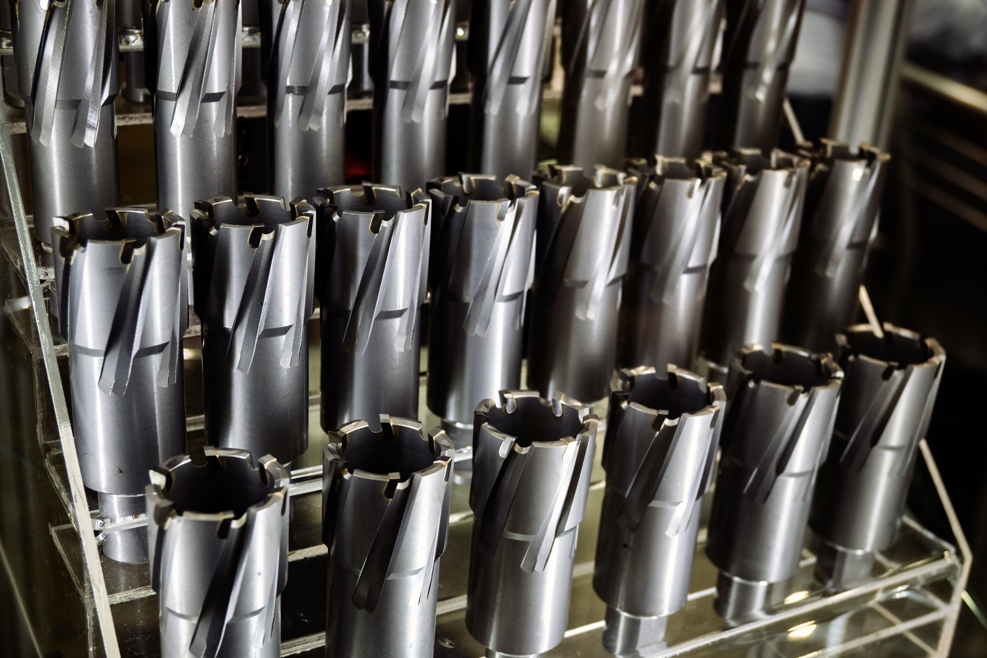 Shelf display of sharp metal drilling tools. Industrial cutters for precise machining and metalworking applications. Close-up view.