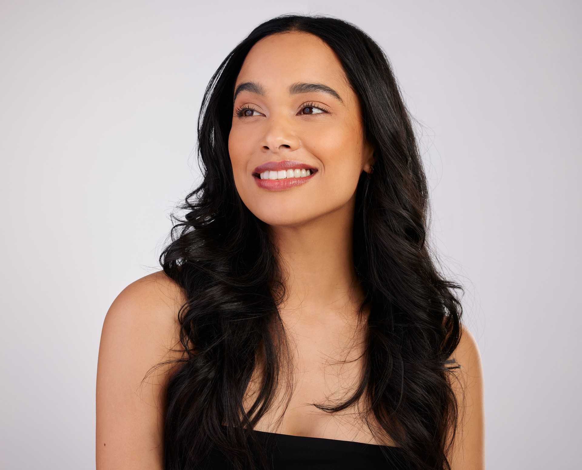 Studio shot of a beautiful young woman posing against a grey background